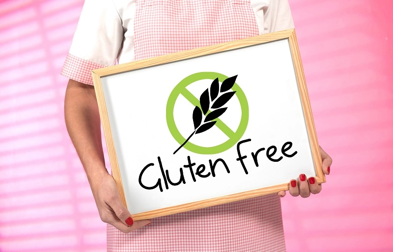 kobieta trzymająca tablicę z napisem gluten free